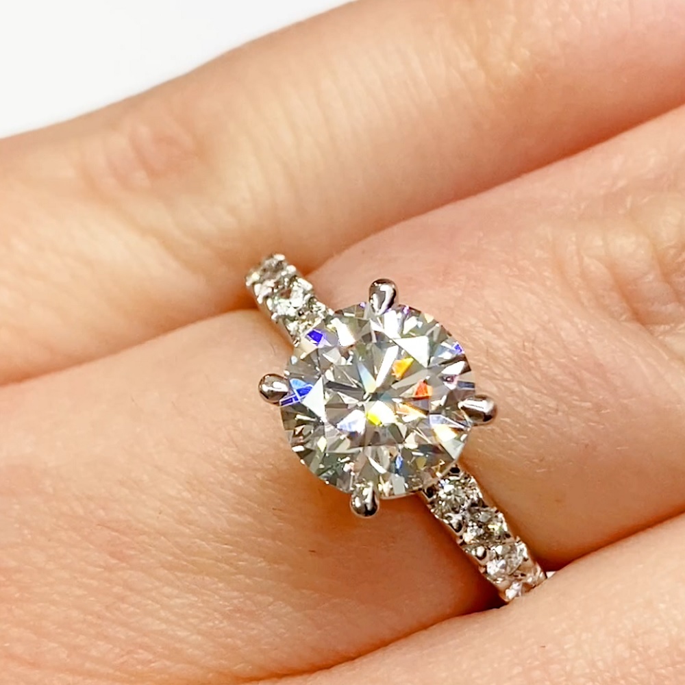 Brilliant cut solitaire with diamond band ring